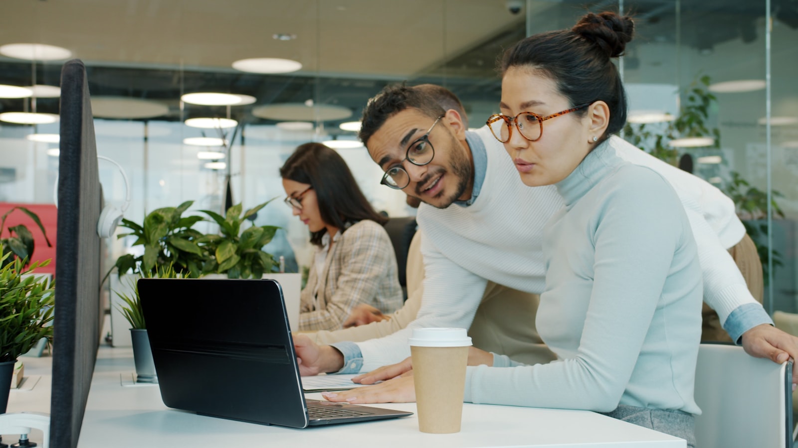 People collaborating on a website at a laptop